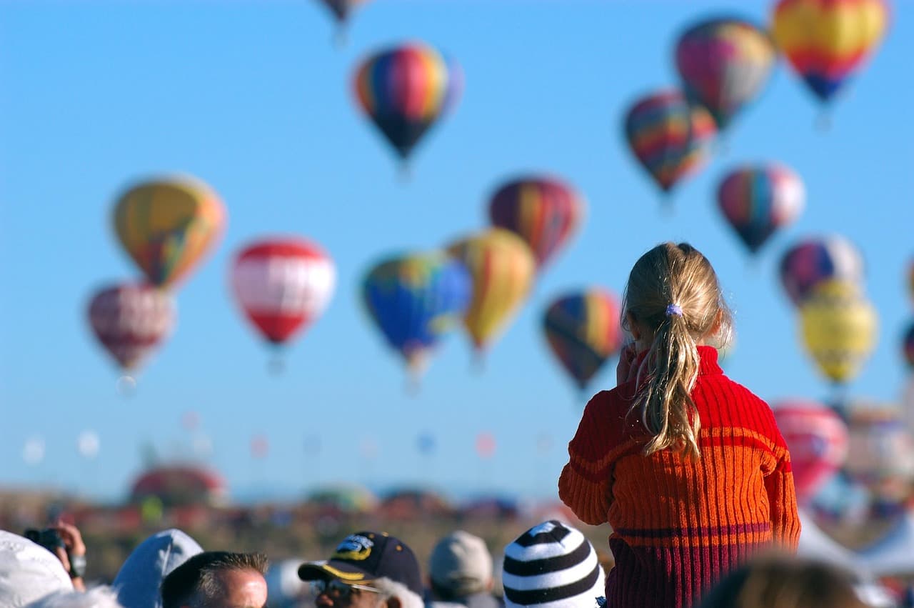 Child watching hot air balloons